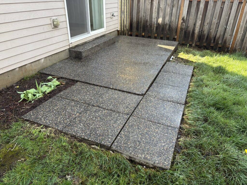 Clean, moss-free patio after pressure washing.