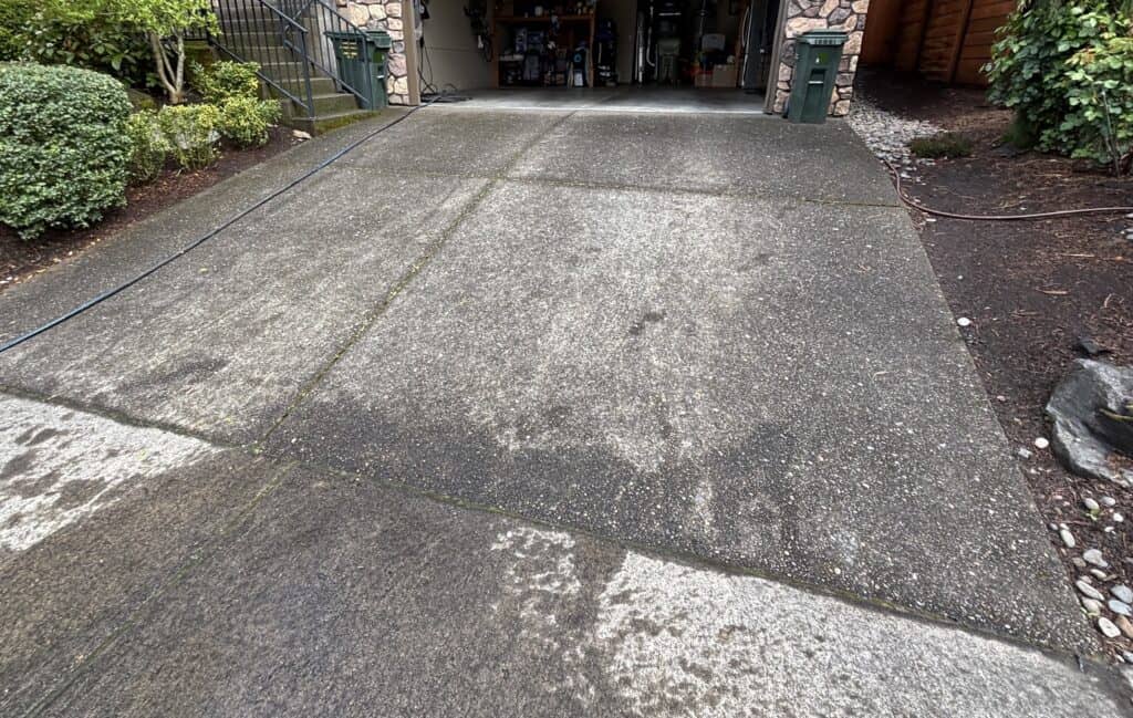 Dirty concrete driveway before pressure washing.