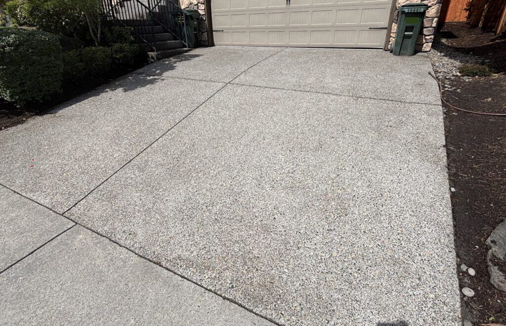 Uniformly clean concrete driveway after pressure washing.